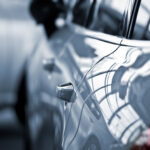 luxury car with focus on the handle to represent Factor Sales